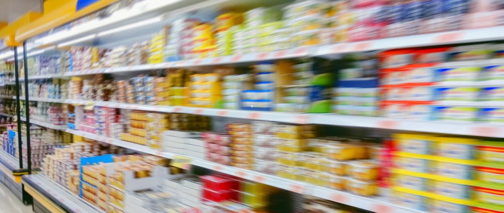 Automated energy management - A supermarket aisle with shelves stocked full of various packaged products. The image is blurred, making specific items and labels difficult to identify. The shelves appear colourful and densely packed. Automated energy management - A supermarket aisle with shelves stocked full of various packaged products. The image is blurred, making specific items and labels difficult to identify. The shelves appear colourful and densely packed.